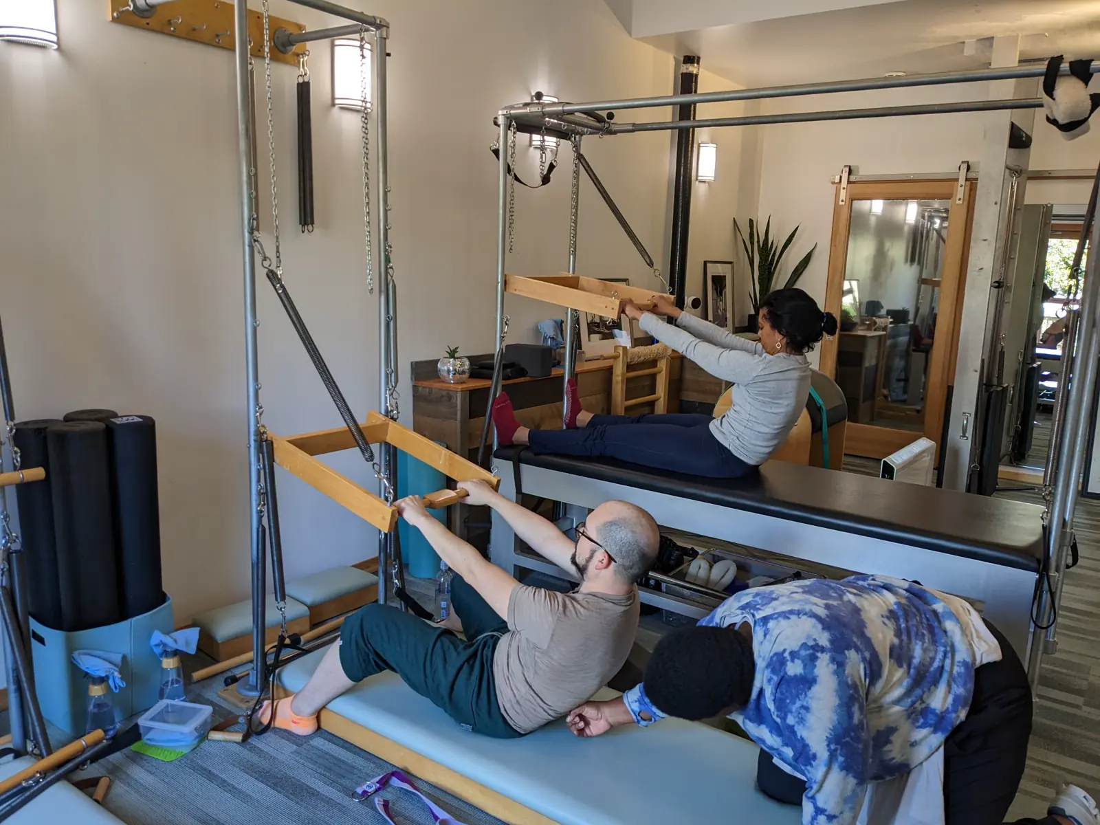 Students practicing together on Classical Pilates equipment