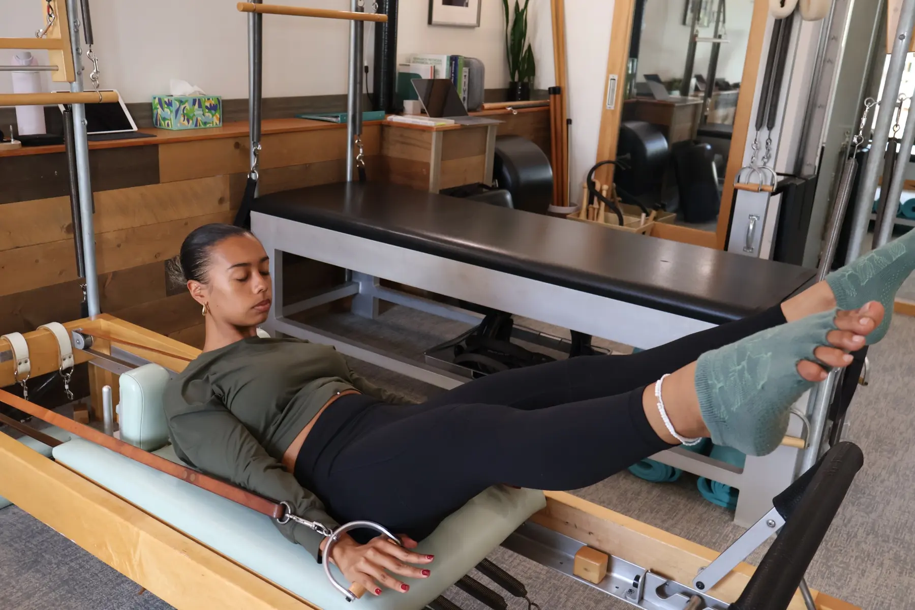 Student practicing controlled footwork on a Classical Pilates Reformer