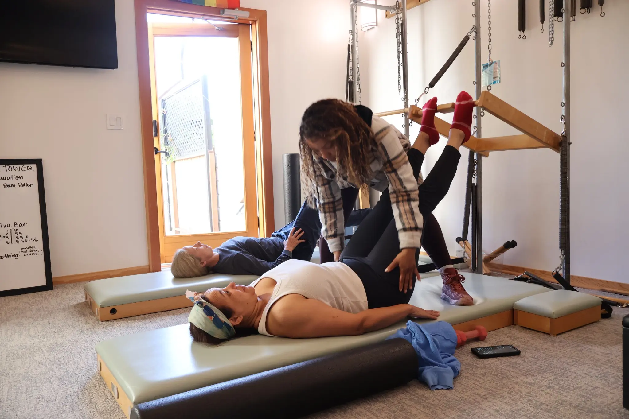 In-Person students receiving hands-on Classical Pilates instruction at Geary School