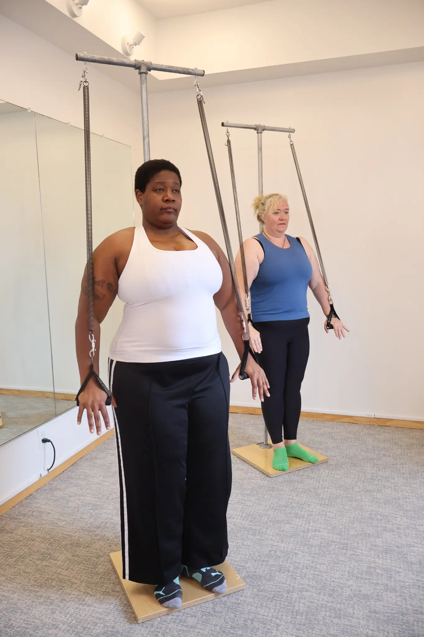 Two In-Person Program students practicing Cadillac exercises at Geary School